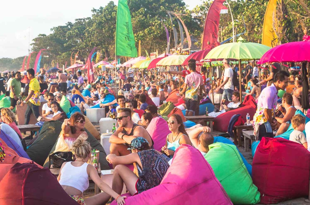 A packed beach club in south Bali at sunset: <em>Munduk vs. South Bali, which side of the island is right for you</em>