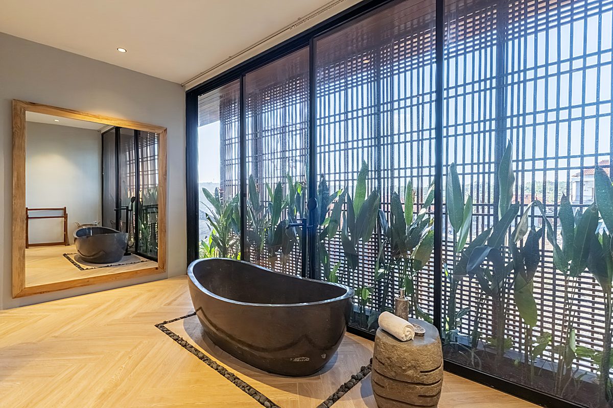 Ocean-view bathroom with stone soaking tub