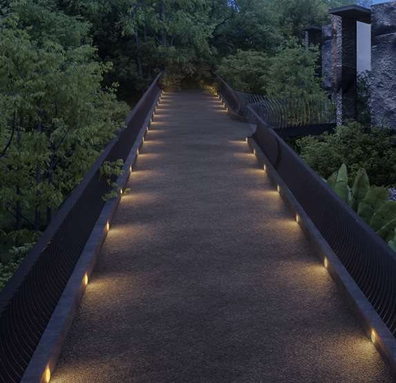 The illuminated suspended road threading through the jungle ravine at dusk at The Heights Munduk